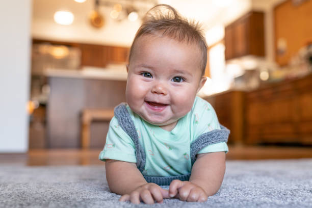 Baby lying on carpet floor | Messina's Flooring